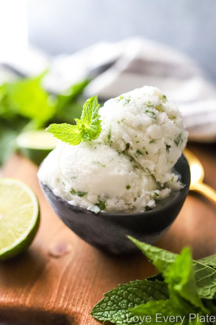 two scoops of coconut lime sorbet with mint leaves on top