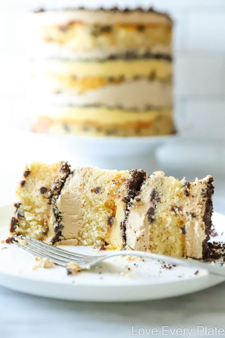 slice of passionfruit layer cake with chocolate topping