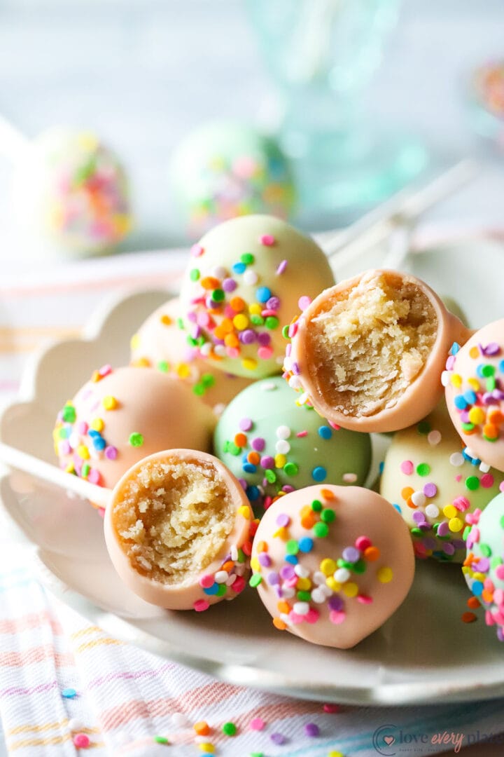 pile of cake pops with sprinkles on a white plate