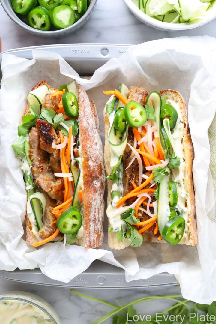 sandwich with pork, mayo, vegetables and herbs