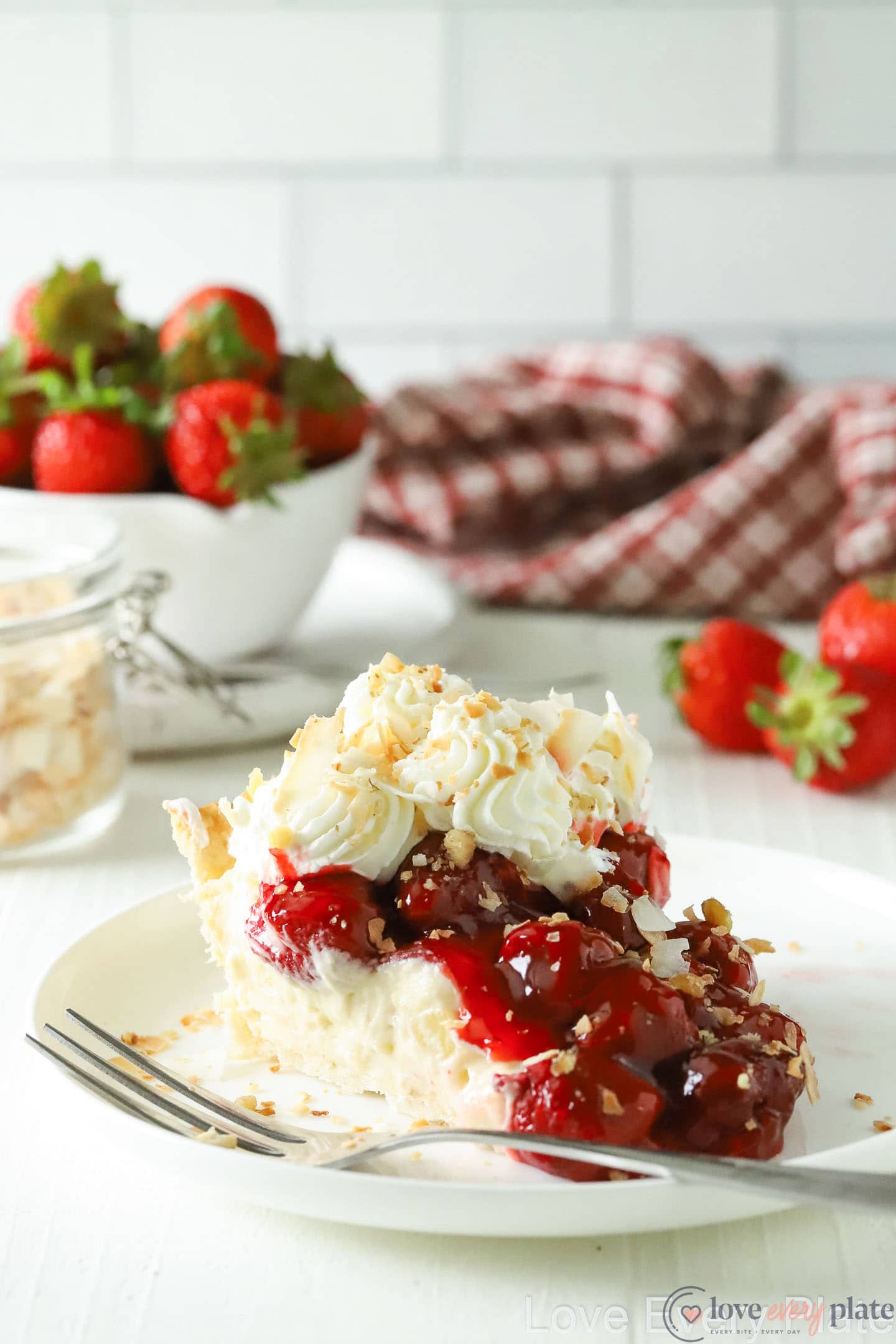 slice of strawberry pie with whipped cream and coconut