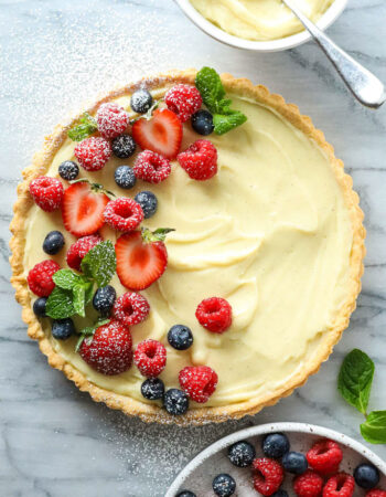 top view of baked tart filled with vanilla cream and topped with berries