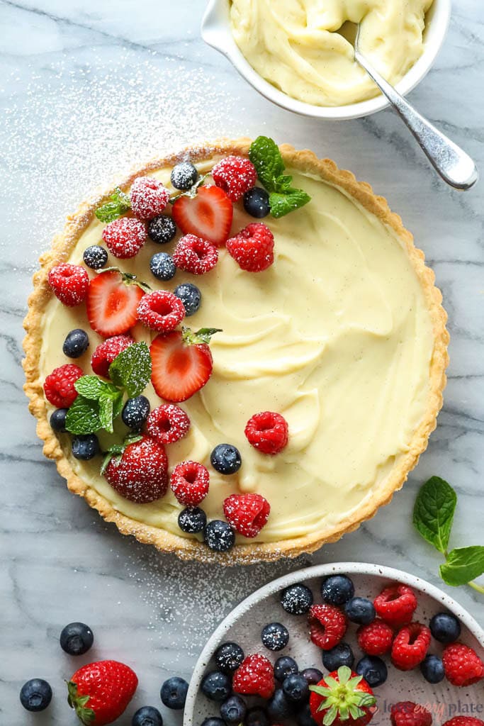top view of baked tart filled with vanilla cream and topped with berries