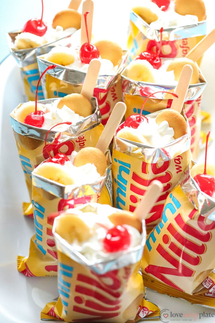 tray of mini vanilla wafer bags filled with banana pudding and cherries.