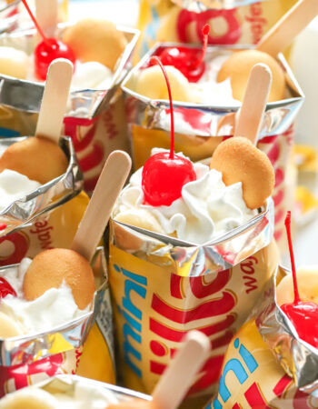 tray of mini vanilla wafer bags filled with banana pudding and cherries.