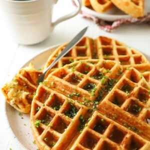 waffles with chives sprinkled on top and a cup of coffee