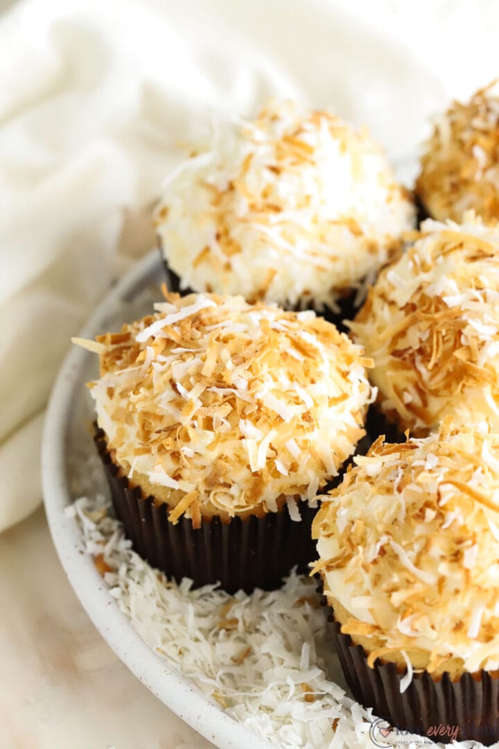 white plate of coconut cupcakes