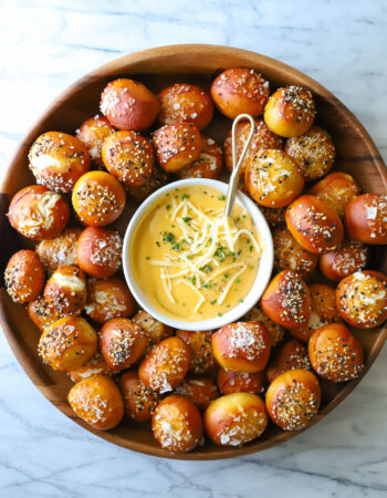 large platter of pretzel bites and bowl of cheese dip in the center