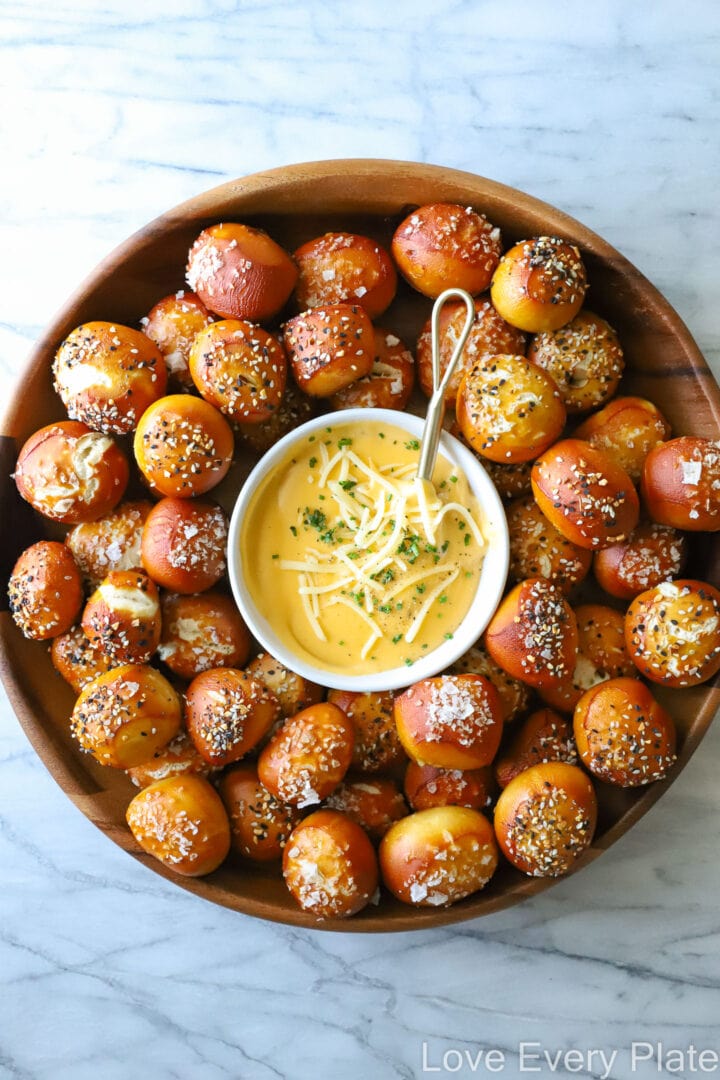 large platter of pretzel bites and bowl of cheese dip in the center