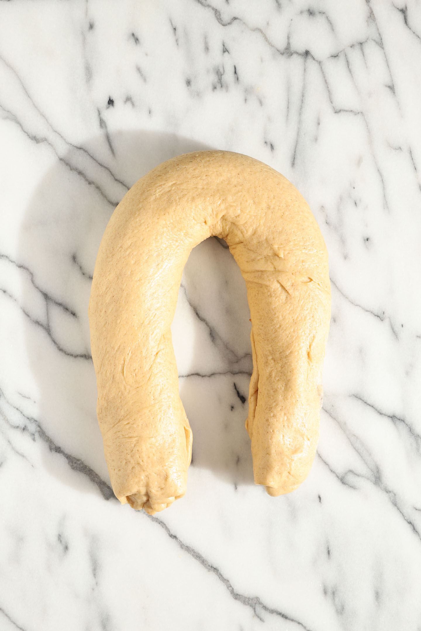 apple babka dough being shaped into a figure 8