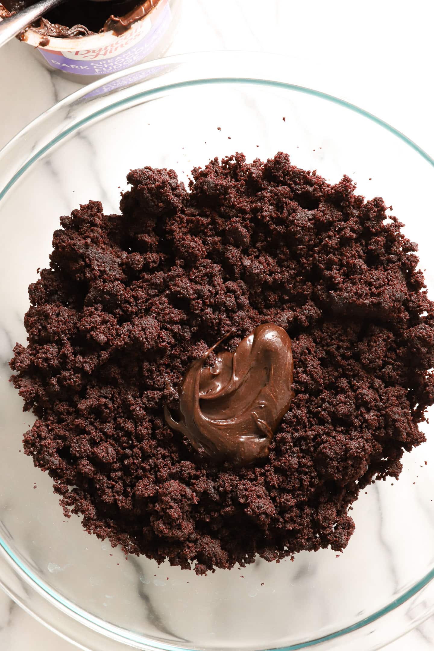 clear bowl of chocolate cake pop mixture before being formed into balls.