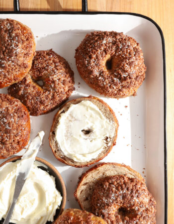 tray of finished cinnamon bagels and a dish of cream cheese