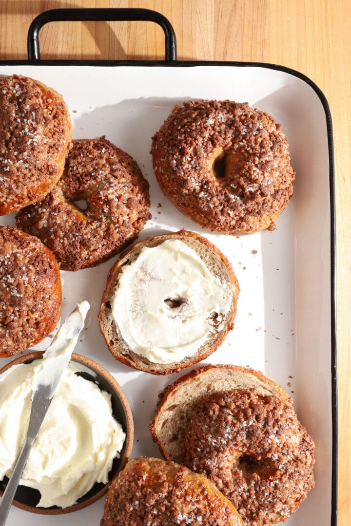 tray of finished cinnamon bagels and a dish of cream cheese