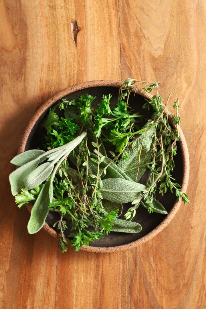 small black bowl of assorted herbs