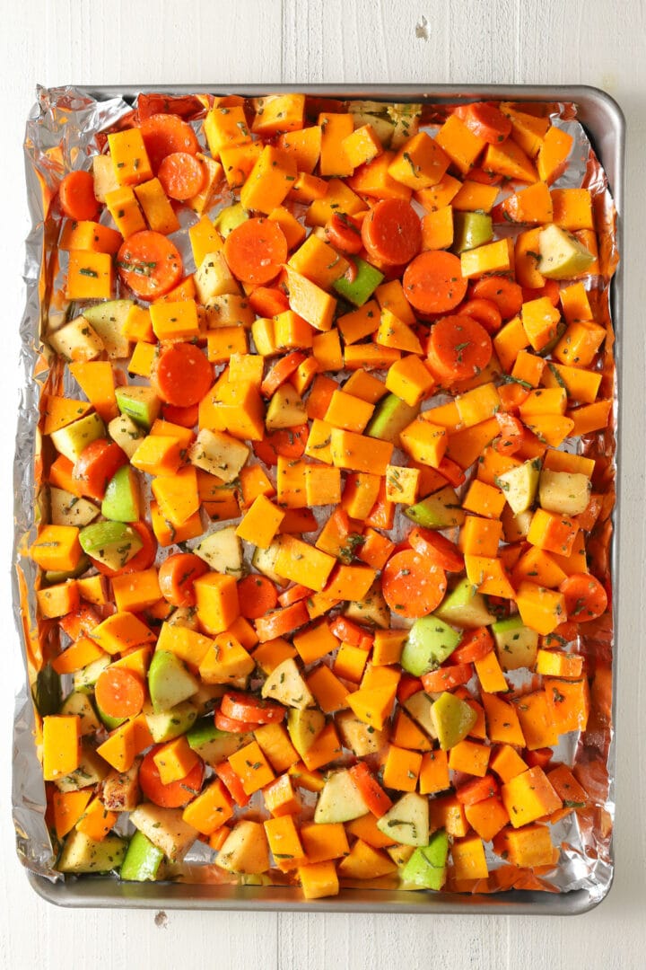 baking tray of cubed squash, carrots and apples before being roasted for soup