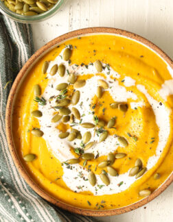 bowl of butternut squash soup and small dish of pepitas