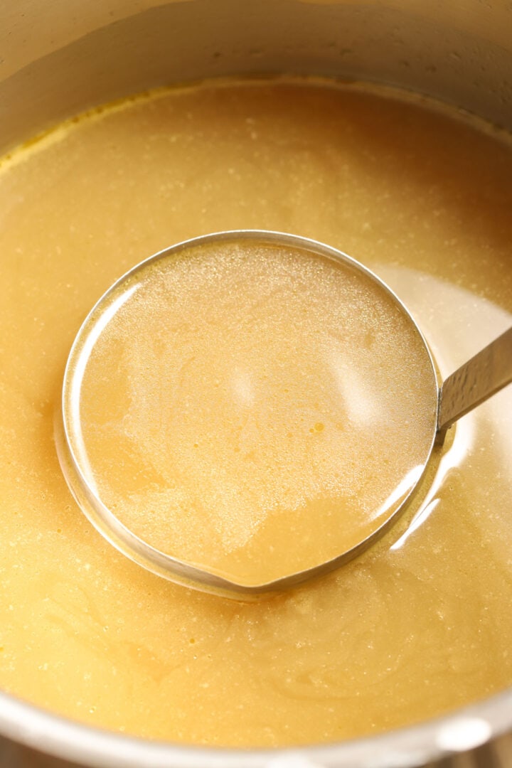 ladle of turkey stock in a pot