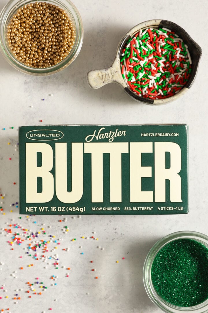 top shot of a pound of butter, surrounded by assorted christmas sprinkles