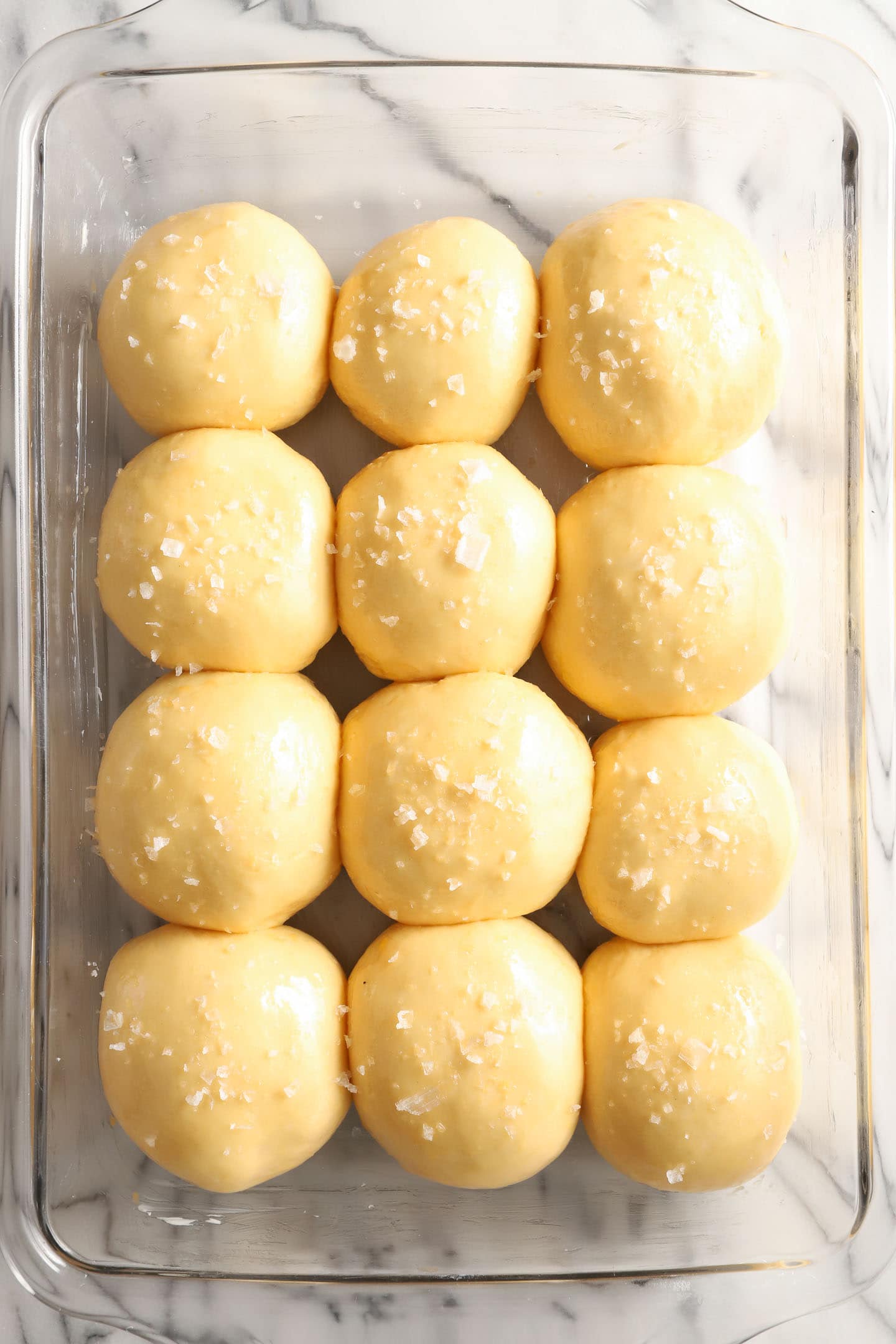 Tray of unbaked rolls with salted tops.