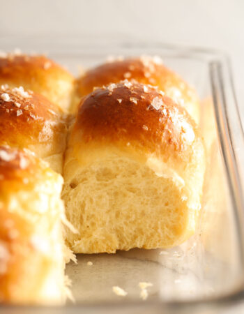 tray of dinner rolls with salt on top. You can see the interior of one roll