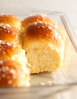 tray of dinner rolls with salt on top. You can see the interior of one roll