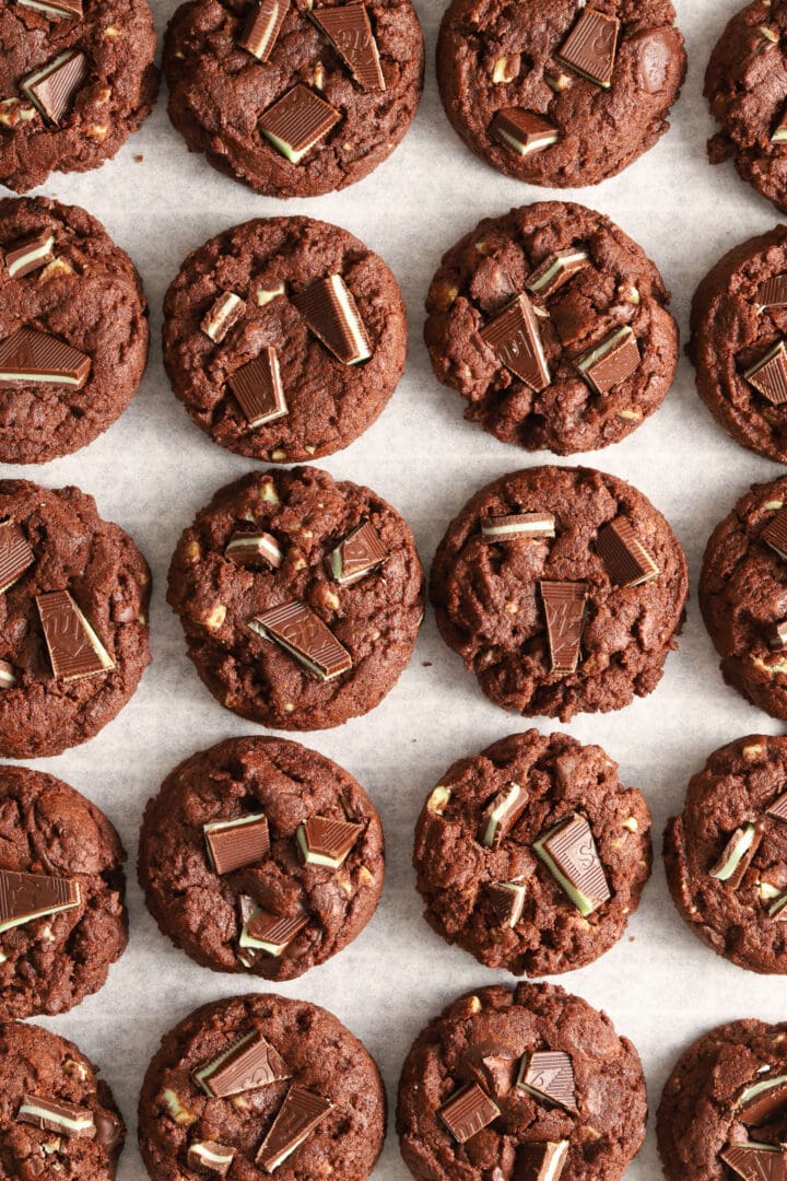 parchment lined baking sheet with chocolate cookies