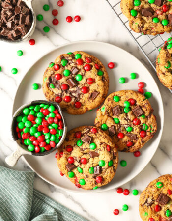 top view of a white plate with three christmas chocolate chip cookies