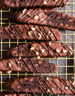 top shot of a gold cooling rack filled with chocolate biscotti.