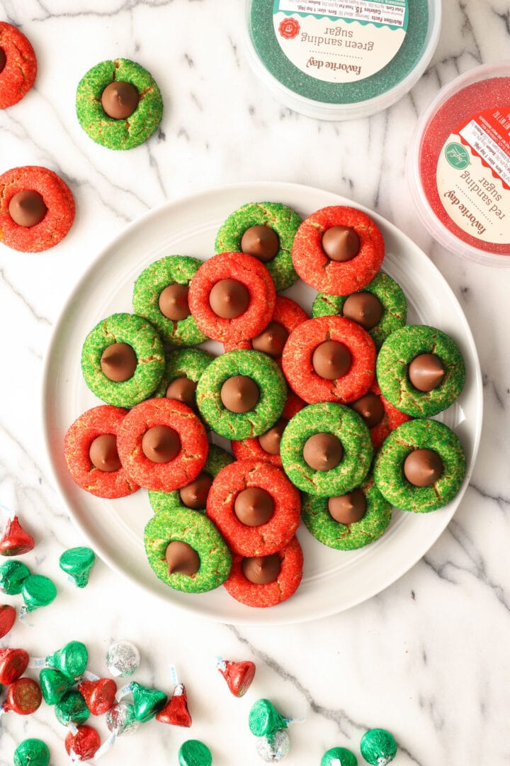 large gray plate of red and green peanut blossom cookies.