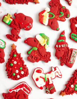 assorted red velvet cut out cookies that are shaped like snoopy and other peanuts characters
