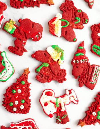 assorted red velvet cut out cookies that are shaped like snoopy and other peanuts characters