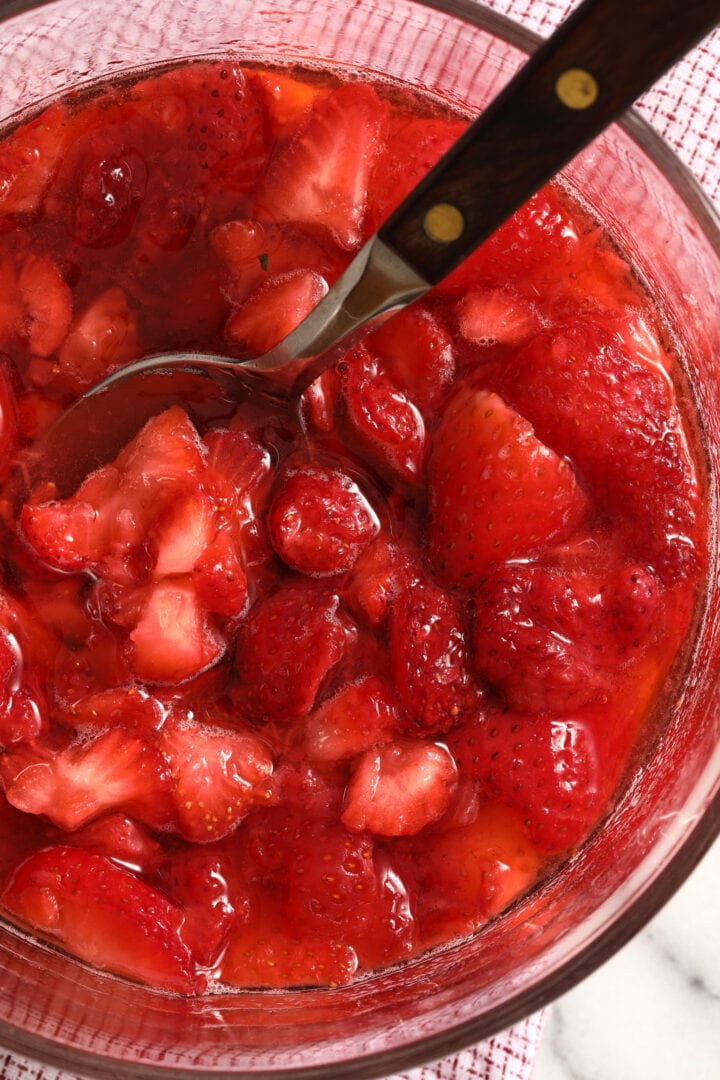 bowl of sliced strawberries in juice