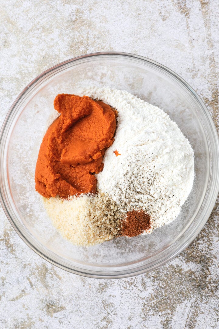 glass bowl of the ingredients to make pumpkin gnocchi dough.