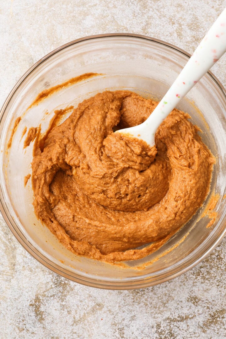 finished pumpkin loaf batter in a large glass mixing bowl.