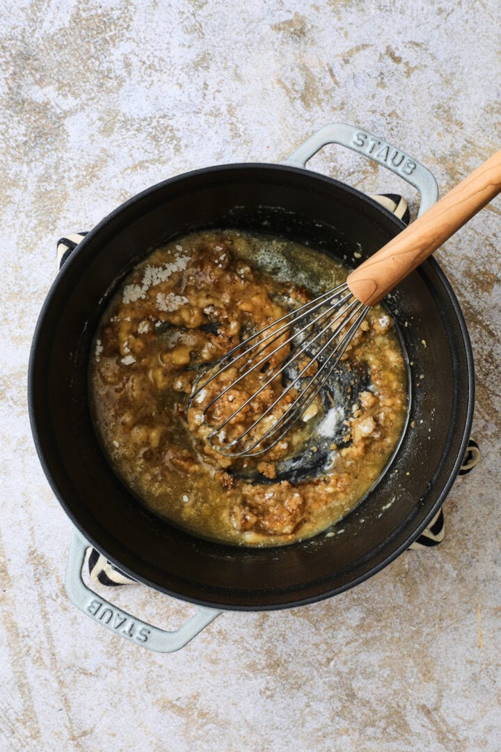 Flour and spices are added to the melted butter to create a roux.